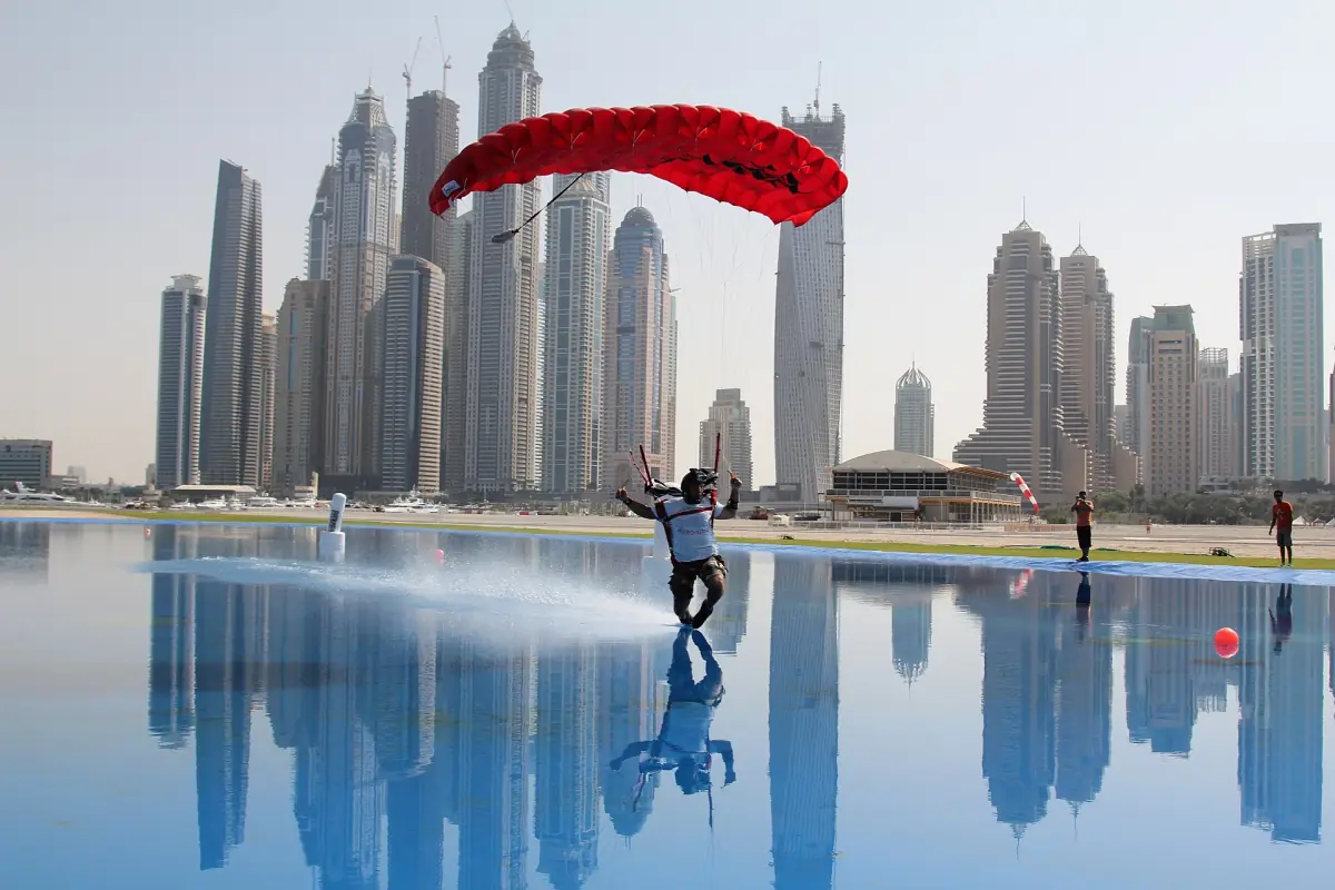 Skydiver landing in front of the Dubai Marina towers