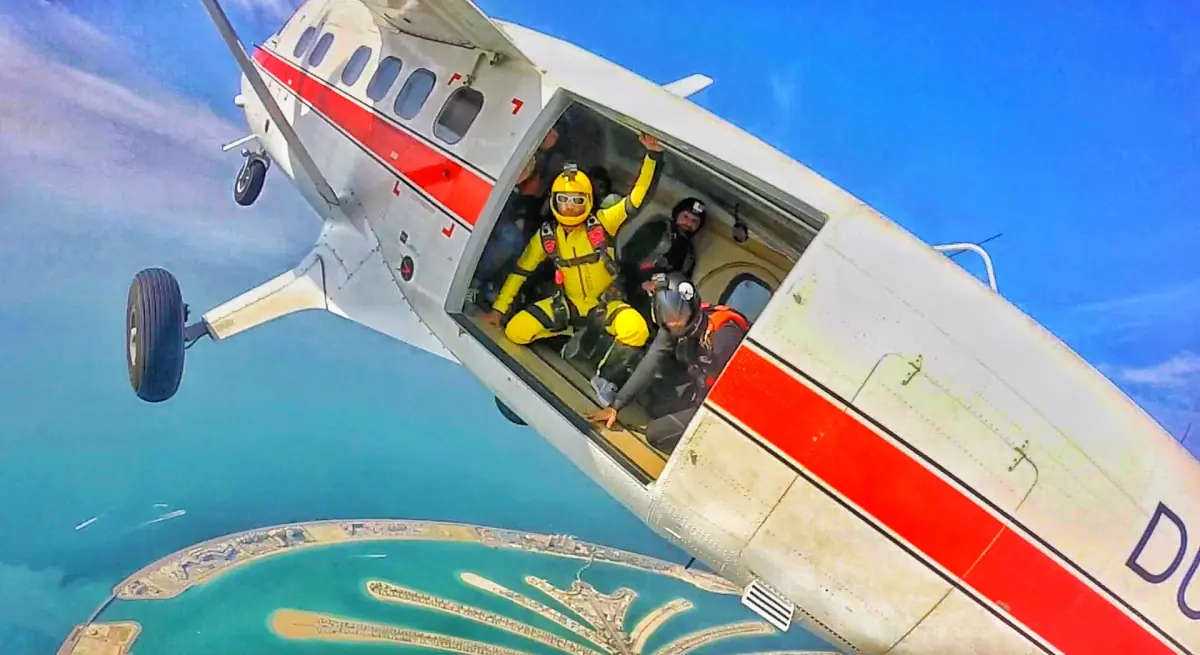 Skydivers at the open door of a plane over Dubai